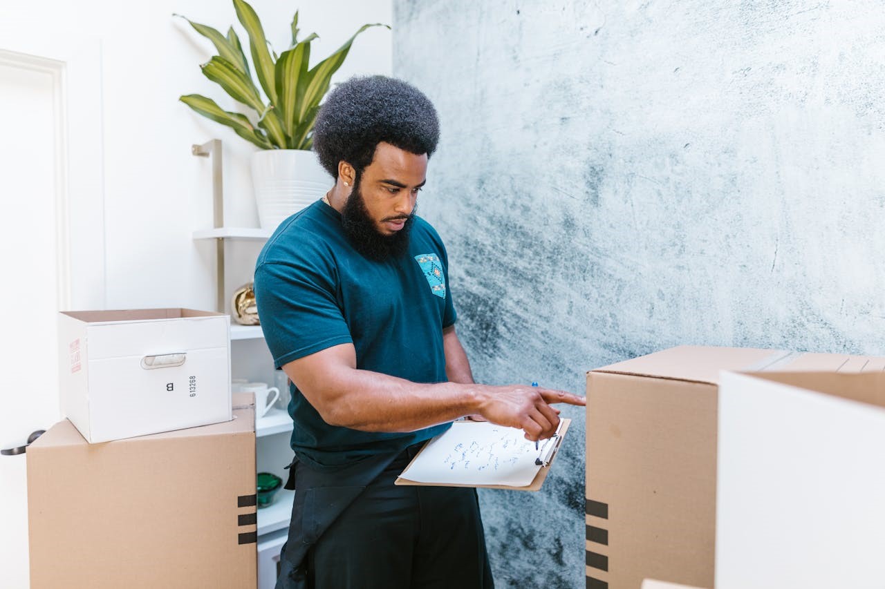 A mover making an inventory of moving boxes